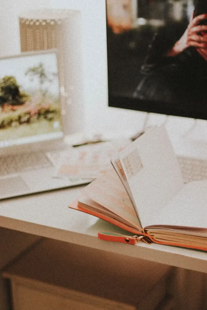 A study workspace with an open planner and laptop